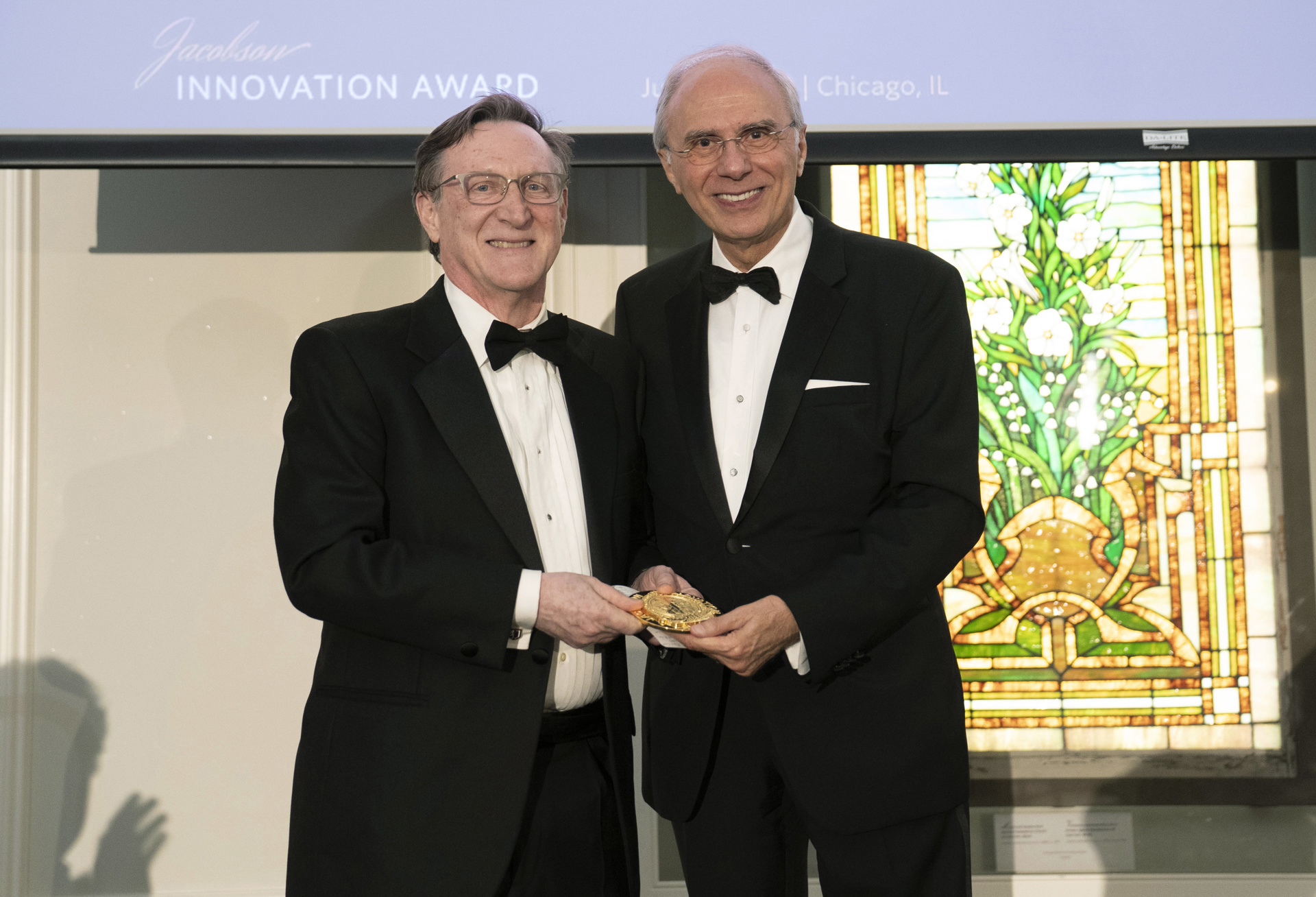 Christian P. Larsen, MD, DPhil, FACS, is presented with the Jacobson Innovation Award by ACS President Anton N. Sidawy, MD, MPH, FACS.