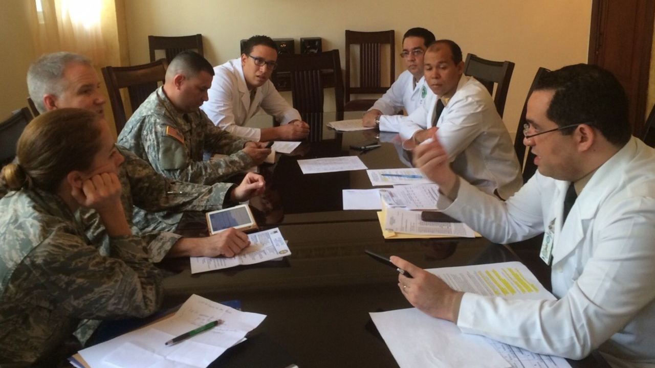 Dr. Kerry Latham (bottom left) and colleagues discuss an international partnership, workflow, resources, and priorities between US and Dominican Republic care teams as part of the patient safety strategy and collaboration process at Hospital Central de las Fuerzas Armadas in Santo Domingo.