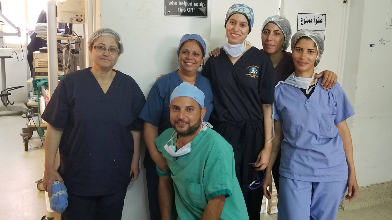 Dr. Youma Sherif (third from right) joins the general surgery OR team of scrubs and circulators on her final day at Harpur Memorial Hospital in Menouf, Egypt.