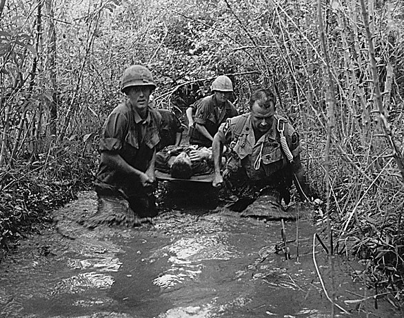 Soldiers carry a wounded comrade, 1969. <br>Still Picture Records Section, The U.S. National Archives, 111-SC-651408. 