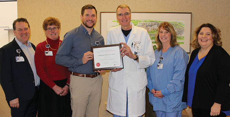 MMMC-Alpena surgeons and hospital leadership with their plaque acknowledging the hospital’s participation in the ACS rural hospital surgical verification and quality improvement program. From left: Mr. Sherwin; Ms. Pokorzynski; Tom Thornton, VPMA and general surgeon; Dr. Puls; Denise Wekwert, OR nurse manager; and Tanya Rouse, surgery program manager.