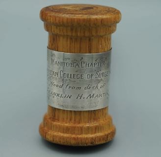 Front-facing inscription: “Manitoba Chapter, American College of Surgeons, Wood From the Desk of Franklin H. Martin.”